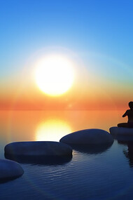 Meditating on sunlit rocks, a person embraces tranquility and connection with nature