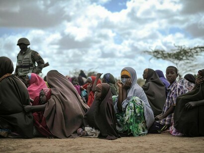 Female internally displaced persons (IDPs) wait at a food distribution center in Afgoye, Somalia, receiving assistance through humanitarian aid efforts