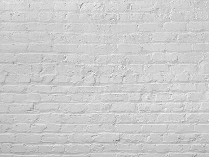 A white-painted brick wall with visible texture