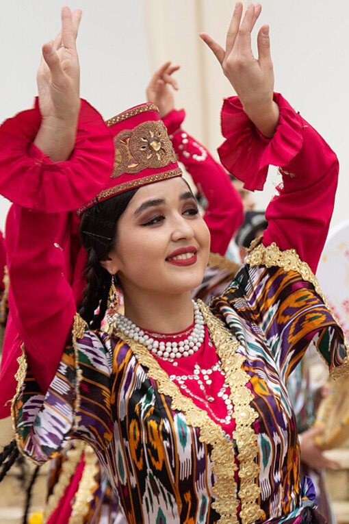 A woman performing a traditional Uzbek dance, celebrating the rich culture and heritage of Uzbekistan