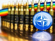 A NATO pin badge in front of bullets, representing the military alliance between member countries to promote peace and security 