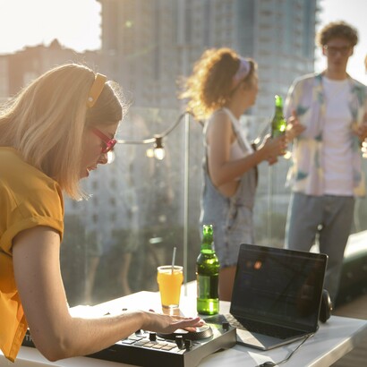 Energetic rooftop gathering of young individuals, reflecting the dynamic atmosphere brands strive to recreate during product launches, which serve as modern rituals, enhancing consumer engagement and brand loyalty