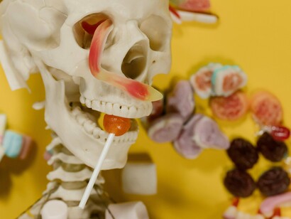 Esqueleto cercado de doces. Mas e o açúcar no nosso dia-a-dia ? Fonte de energia, o produto pode ser encontrado nas mais diversas formas; desde a indústria alimentícia, a farmacêutica, aos cosméticos; dentre tantos outros usos. É comum encontrarmos o produto em bebidas, onde ele tem uma função adoçante, em outros alimentos na forma de conservante; e atuando também como agente de textura e de sabor

