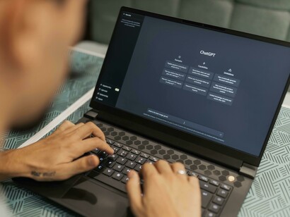 A man using a laptop with ChatGPT, illustrating artificial intelligence running locally on a personal computer