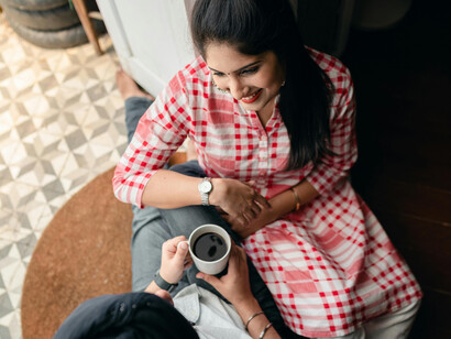 A happy married Indian couple enjoys specialty coffee at a modern café—part of the growing culture of coffee as a lifestyle in urban India