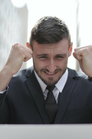 Man in suit celebrating success