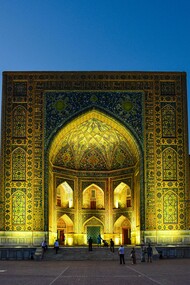 Night view of the Tilya Kori Madrasah in Samarkand, Uzbekistan, famed for its golden interiors and role as both a mosque and madrasa