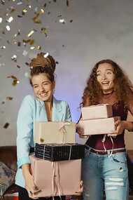 Two women joyfully exchanging thoughtful gifts, reveling in the celebration of Galentine's Day