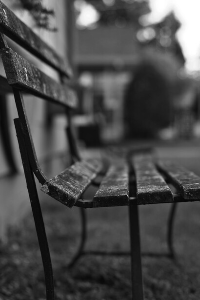 An empty bench sits in quiet solitude, overlooking deserted streets, echoing a sense of melancholy