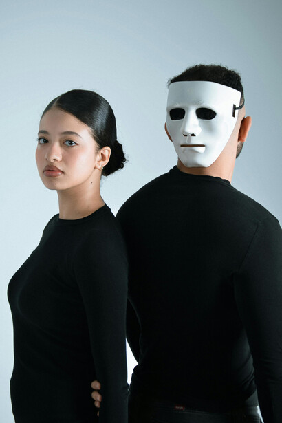 A mysterious scene featuring a masked figure and a woman