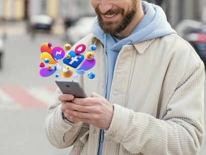 Various emojis and notifications popping out of a man's phone, symbolizing the constant distractions and pressures of technology