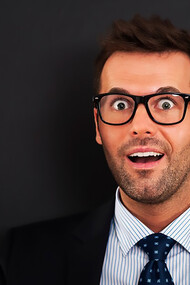 A businessman or CEO, looking happy and calm, has a breakthrough idea