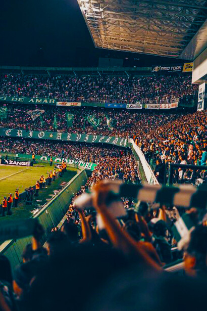 A stadium packed with football fans eagerly watches the match