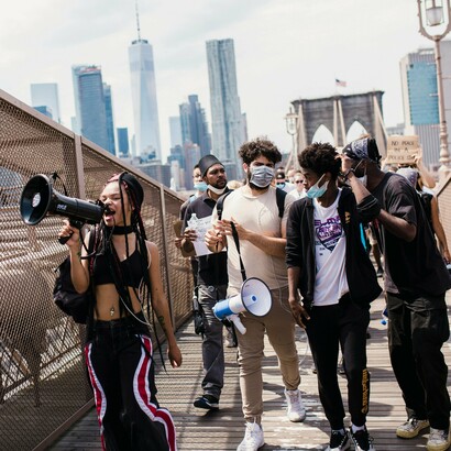 Their voices echo across the bridge, demanding a world where Black lives are no longer up for debate