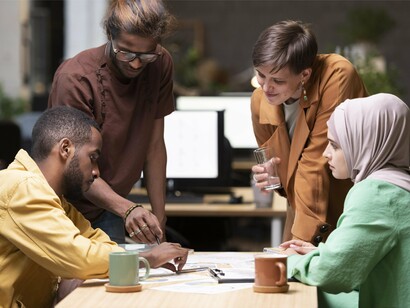People from varied cultures working side by side, illustrating the collaborative ties that educational exchanges build across nations