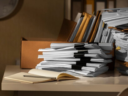 Stacked documents symbolizing bureaucratic paperwork