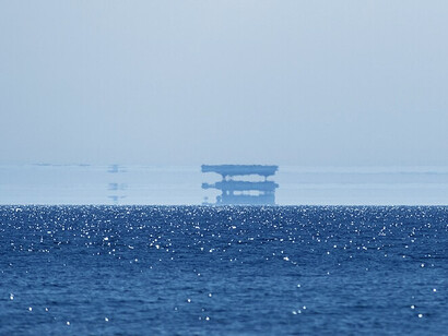 A Fata Morgana seen over the Baltic Sea, 2016. The mirage consists of multiple upright and inverted images over the original object