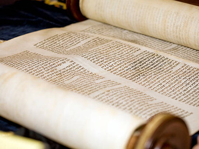 A Torah scroll inscribed in Hebrew religious script