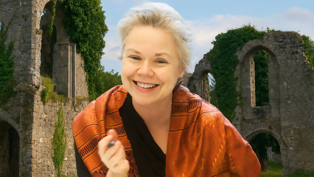 Susan Stewart pictured against a backdrop of ancient ruins, reflecting her lifelong engagement with memory, materiality, and the traces of the past