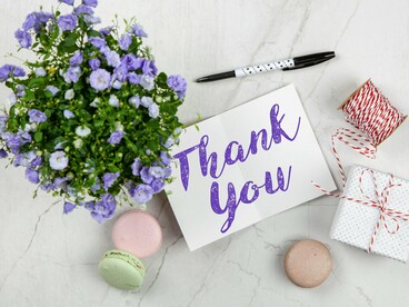 A handwritten card of thanks accompanied by small delights, illustrating how appreciation rewires emotional focus