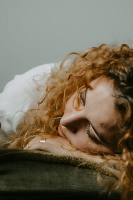 A woman in a gray sweater holding her smartphone