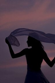 A woman holding a scarf as a symbol of self-expression, empowerment