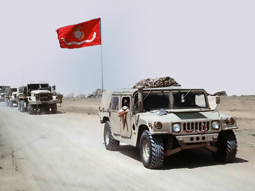 An M998 High-Mobility Multipurpose Wheeled Vehicle (HMMWV) leads a convoy of Marines from Headquarters Battalion, 2nd Marine Division, as they move toward Jubail, Saudi Arabia, after being stationed west of Kuwait City during Operation Desert Storm