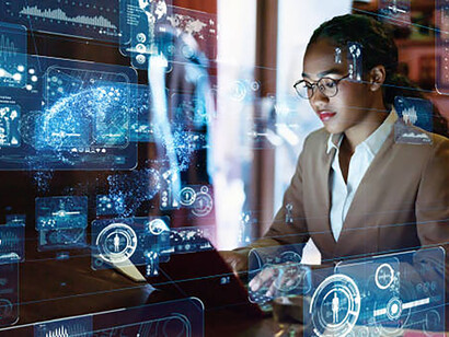 A young woman working late in the office, focused on systems engineering and driving digital transformation with generative AI technology