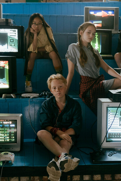 A group of teenagers playing retro video games on a TV, immersed in a nostalgic gaming atmosphere