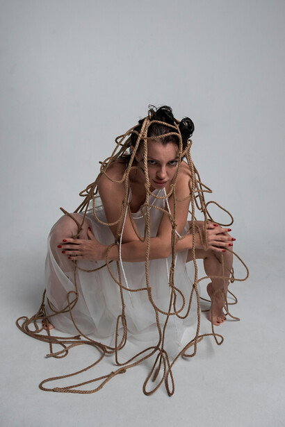 Woman caught in a net, symbolizing the struggle for freedom