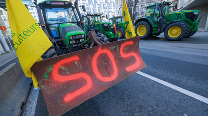 Farmers’ protest in Brussels, with a tractor carrying a sign reading ‘Sos'