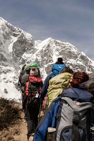 People working together to climb a mountain