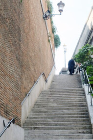 A man walking up countless steps 