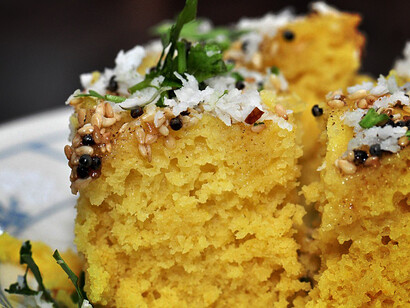Dhokla is often tempered with mustard seeds and garnished with fresh coriander and grated coconut