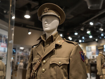 Behind the glass, a military uniform is carefully displayed