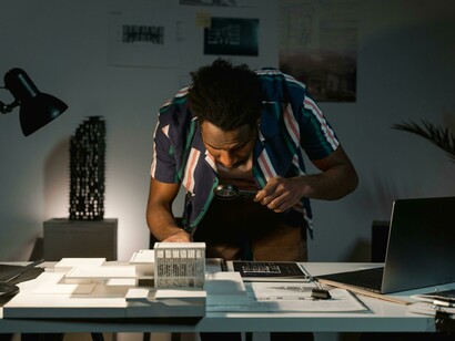 Man sitting behind his work table feeling exhausted