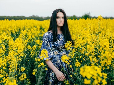 A woman resting in stillness among wildflowers, representing the serenity of a healed love identity