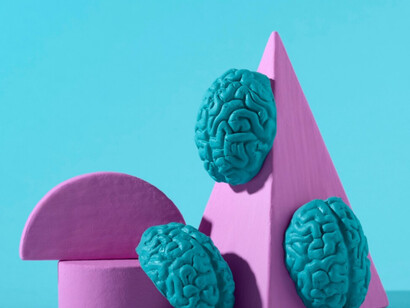 A closer view of geometric figures and brain showcasing how human creativity cannot be compared to AI