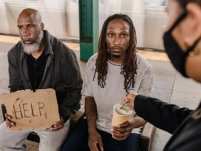 Two men in New York seeking assistance—highlighting the everyday reality of urban poverty
