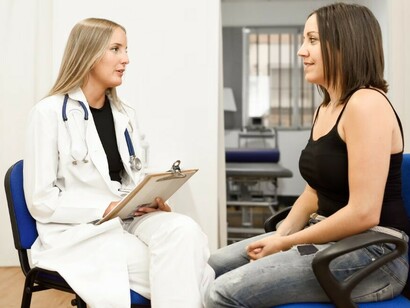 A female doctor carefully walks her young patient through the diagnosis, emphasizing clear communication and empathy