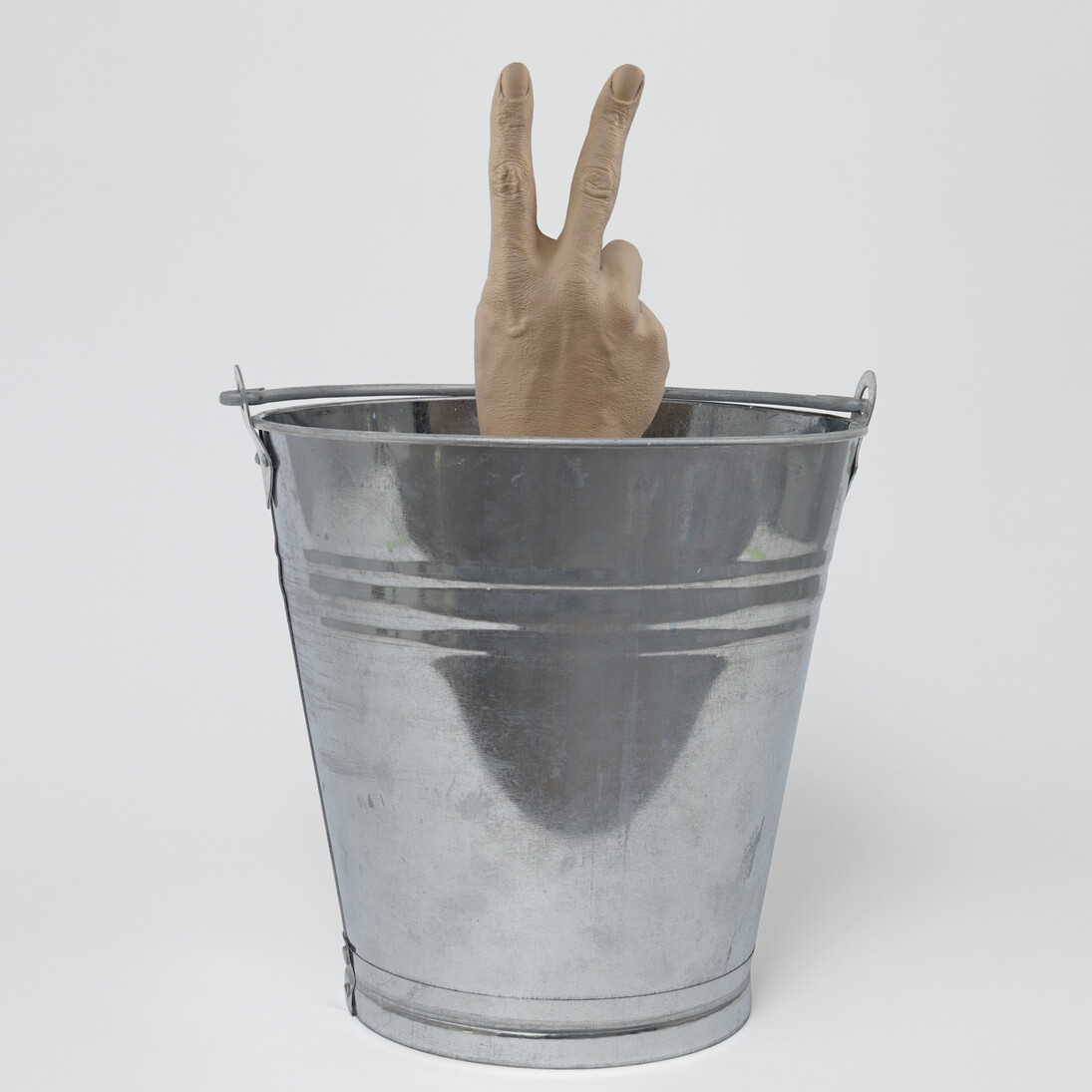 Djordje Ozbolt, Shallow Victory, 2014, Metal bucket, resin, mixed media hand, 46 x 33.5 x 33.5 cm / 18 1/8 x 13 1/4 x 13 1/4 in. Photo: Genevieve Hanson © Djordje Ozbolt. Courtesy the artist and Hauser & Wirth