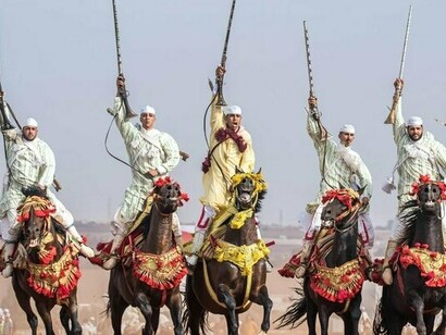 Traditional Moroccan Fantasia horsemen in coordinated motion, representing the discipline and continuity at the heart of Morocco’s diplomatic model