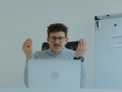 An overwhelmed employee sits at his desk, reflecting the toll that burnout and a toxic work environment can take on mental health