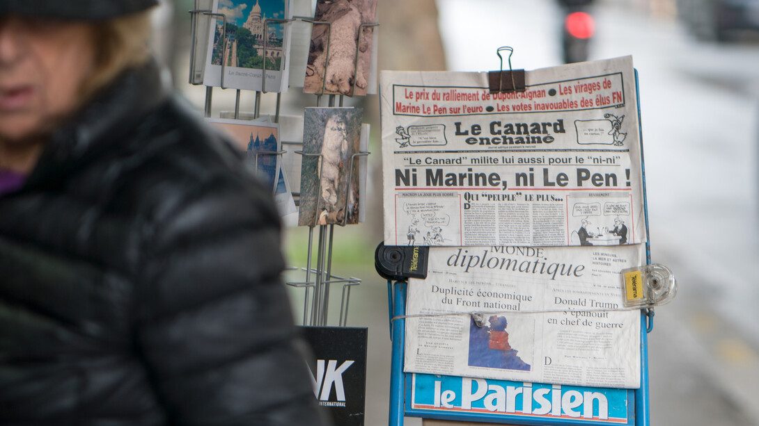 Newspapers displayed on the streets of France, capturing the essence of daily life and media culture