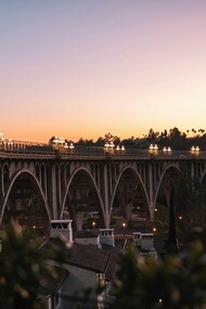 The Colorado Street Bridge glows at dusk, a timeless Pasadena landmark linking history, architecture, and California charm