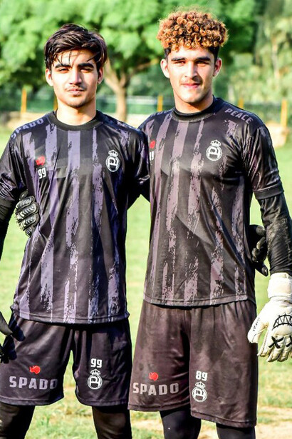 A group of Popo FC players huddles before a match, reflecting unity and determination in Pakistani youth sports