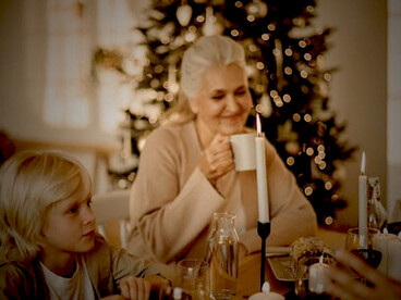 A family comes together around the table, enjoying a warm and joyful Christmas feast