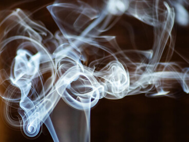 Smoke ascending and slowly dissolving into the air