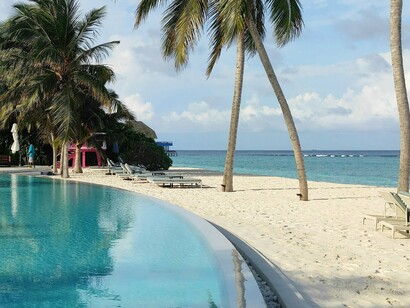 Resort life is defined by calm waters, palm trees, and open horizons