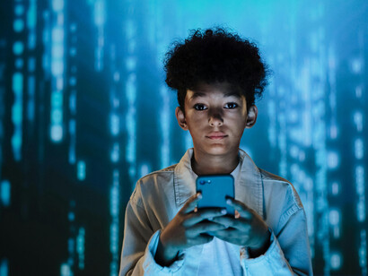 A teen boy set against a futuristic digital backdrop, representing artificial intelligence and rapid AI processing